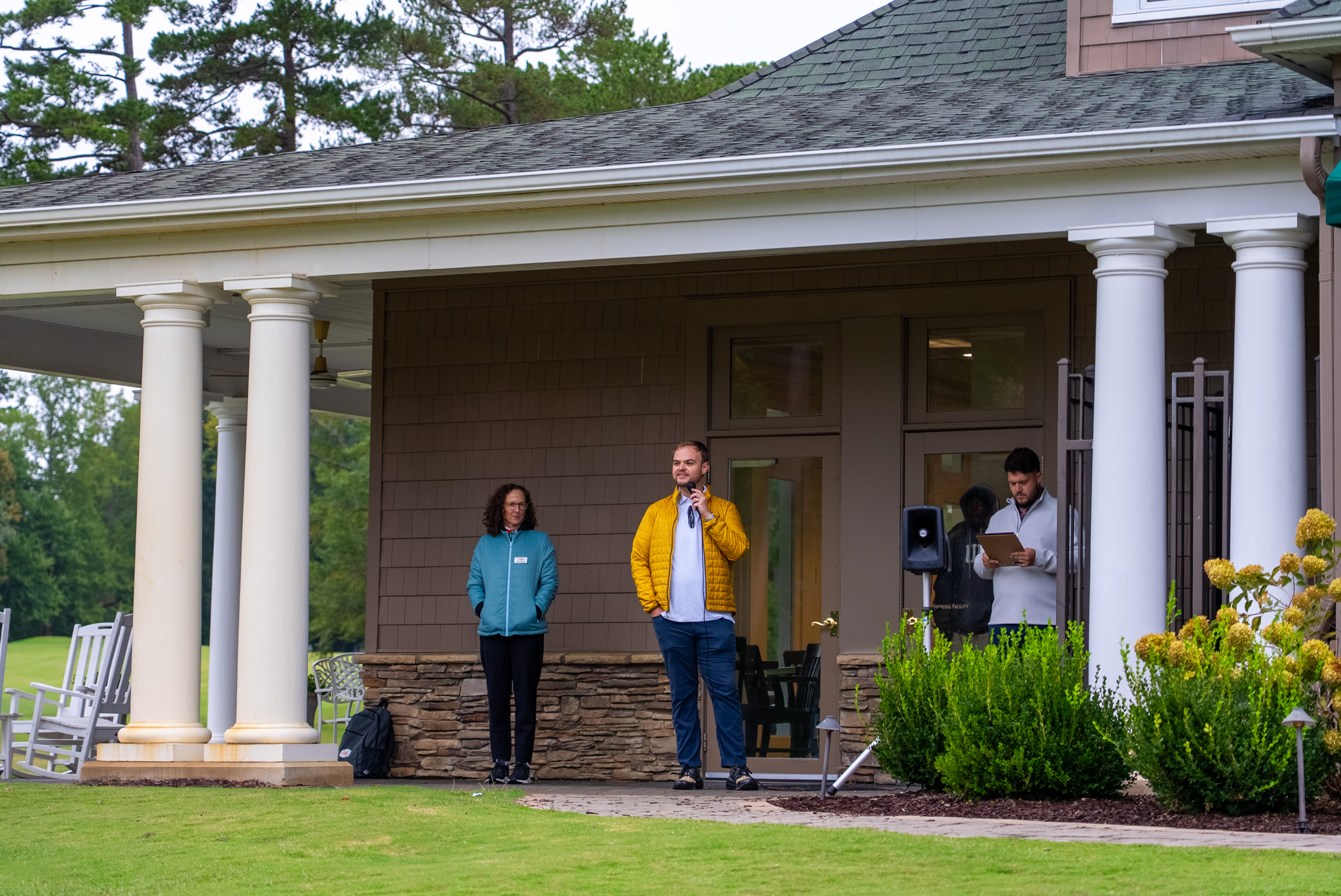 Opening announcements on the clubhouse porch at the 2026 USI Open