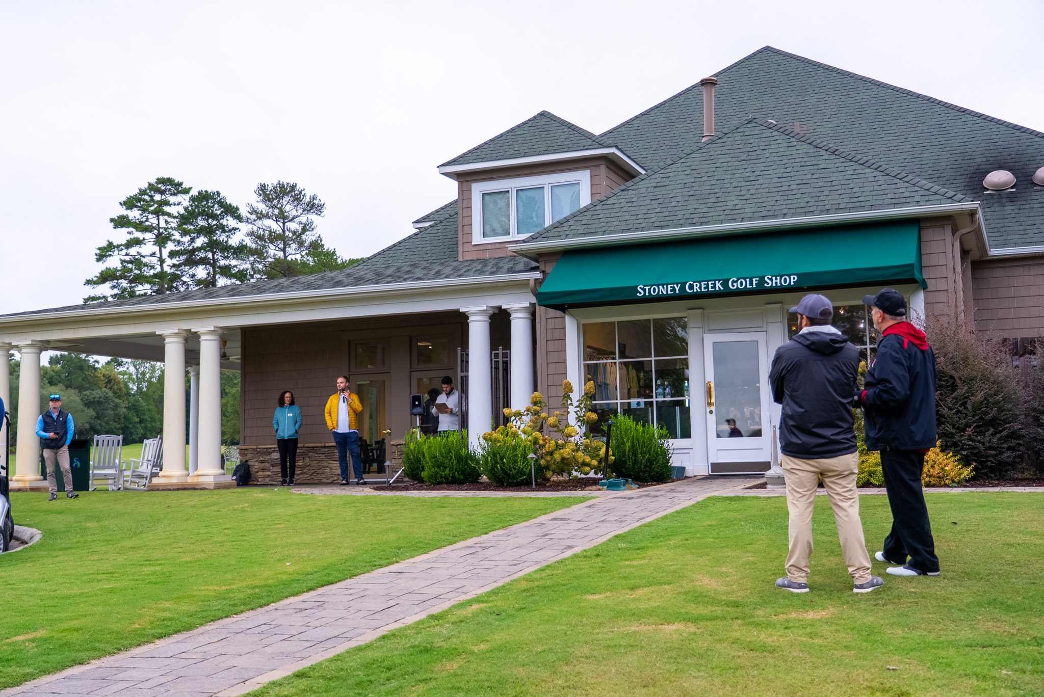Stoney Creek Golf Shop facade with guests on the lawn